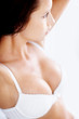 Busty lingerie model against white background