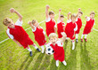 Happy confident players with hands raised on playground