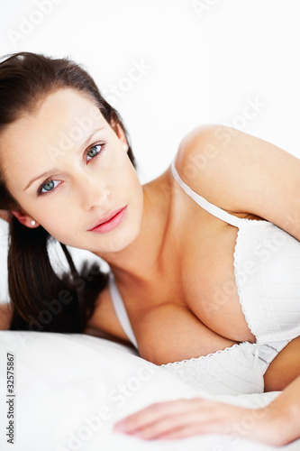 Photo: Lovely female in lingerie lying on bed Lovely female in lingerie lying on bed