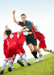 Soccer kids having fun with their coach on field