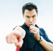 Foto: Football referee blowing whistle and pointing finger towards you Football referee blowing whistle and pointing finger towards you
