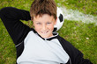 Cute little football player relaxing head on a ball on field