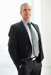 Confident senior business man standing with hands in pocket