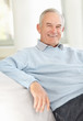 Closeup of a happy senior man relaxing on couch