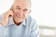Senior man talking over the mobile phone with copyspace