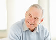Closeup of a cheerful mature man looking away