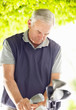 Casual elderly man with golf clubs