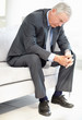 Closeup of a sad business executive sitting on sofa