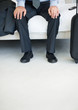 Foto: Low section of a business man with mobile and luggage Low section of a business man with mobile and luggage