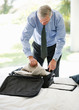 Mature man preparing for his business trip