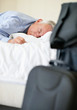 Tired senior business man lying in bed