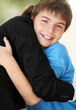 Photo: Happy young boy hugging his mother Happy young boy hugging his mother