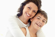 Caring mother embracing her son against white background