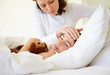 Photo: Caring mother feeling the forehead of sick boy Caring mother feeling the forehead of sick boy