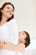 Foto: Happy young boy hugging his mother from back Happy young boy hugging his mother from back