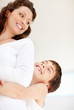Foto: Cheerful son embraces his mother from back Cheerful son embraces his mother from back