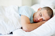 Middle aged man sleeping in bed at home