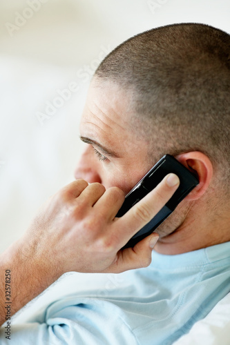 Foto: Side view of a middle aged male over the cellphone Side view of a middle aged male over the cellphone