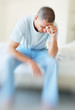 Middle aged male having headache holds his head hard in pain