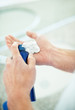 Man's hand preparing to shave with shaving cream