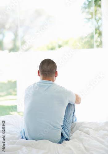 Foto: Middle aged male sitting in his bedroom at home Middle aged male sitting in his bedroom at home