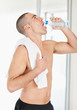 Middle aged man with a napkin while drinking water from a bottle