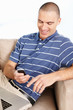 Middle aged man with laptop while reading a text message