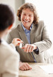 Happy businessman taking room keys from the hotel receptionist