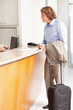 Middle aged businessman standing at the hotel reception