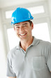 Happy young male architect wearing a helmet