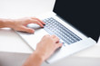Detail view of a young executive lying on laptop