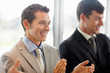 Business men applauding during a meeting in the office.