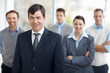 Middle aged man with his team in background