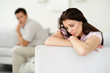 Relationship problem - Worried young couple sitting separately o
