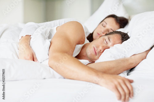 Photo: Attractive young couple sleeping together Attractive young couple sleeping together
