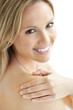 Closeup of happy pretty woman touching her shoulder