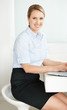 Attractive young female executive using a laptop at desk