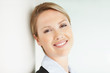 Relaxed beautiful young business woman giving you a smile