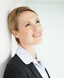 Beautiful young business woman looking away in thoughts