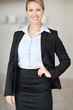 Success - Confident happy business woman with hand on hip