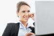 Portrait of a smiling pretty business woman using a laptop