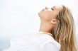 Side view of a peaceful woman against the bright sky