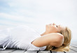 Side view of a peaceful woman lying relaxed on a porch