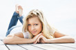 Beautiful female lying down on a wooden porch