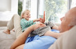 Father and son having fun while lying in bed at home