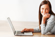 Photo: Happy middle aged female using laptop with copyspace Happy middle aged female using laptop with copyspace