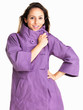 Happy young woman wearing winter coat while posing against white