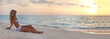 Young lady in bikini sitting relax on the beach