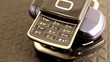 Cellphone pile with one on top showing keyboard rotating