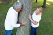 Smiling mature couple standing at tree